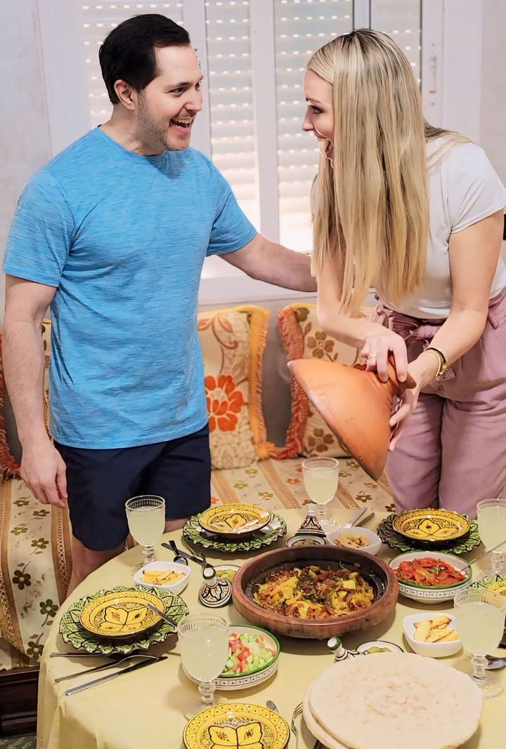 Couple laughing at the set dinner table