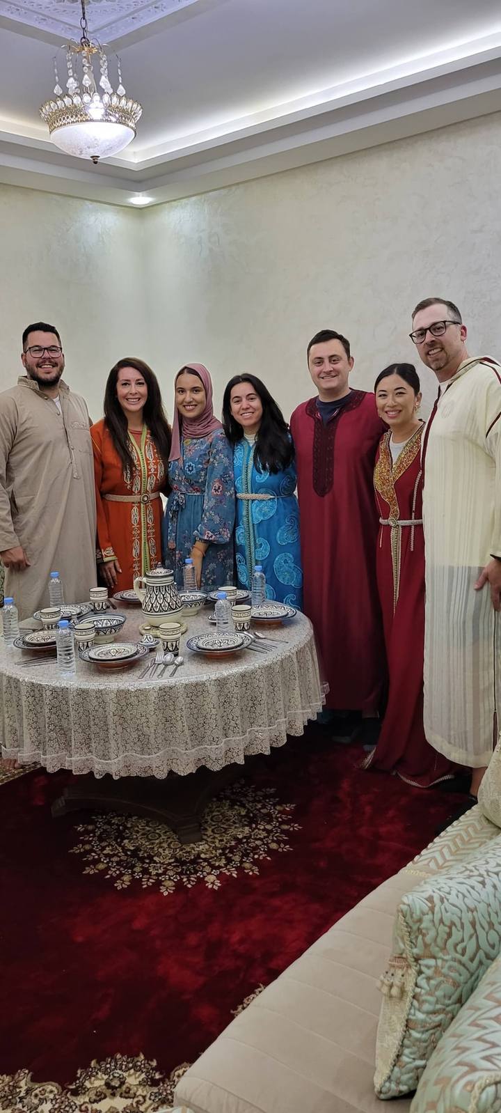 Group of guests in traditional Moroccan dress around the dining table