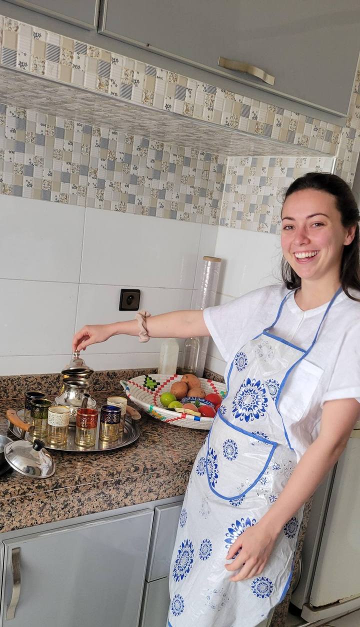 Guest in an apron making tea in the kitchen