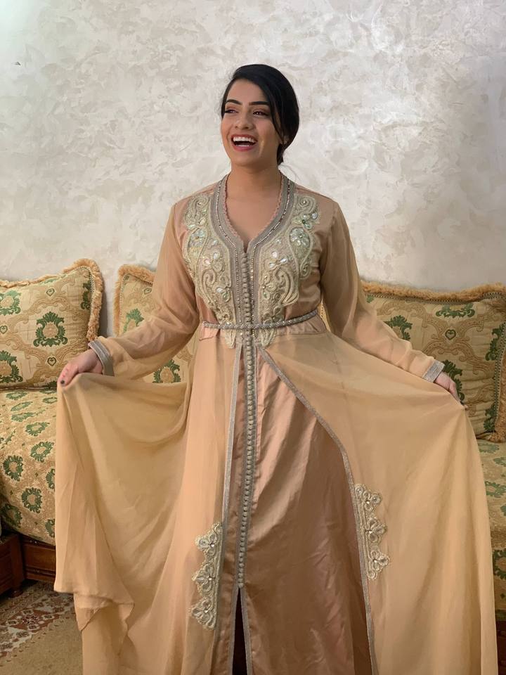 Woman in a gold embroidered caftan