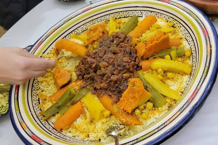 Couscous with caramelised onion tfaya being served
