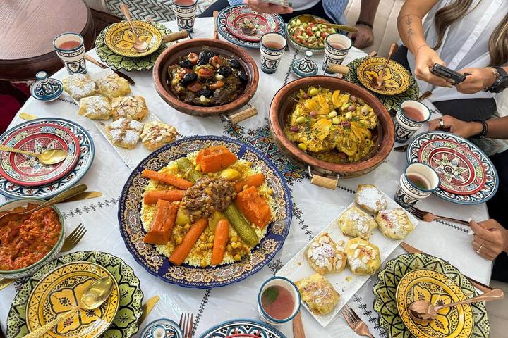Long table laid with couscous, tagines and salads
