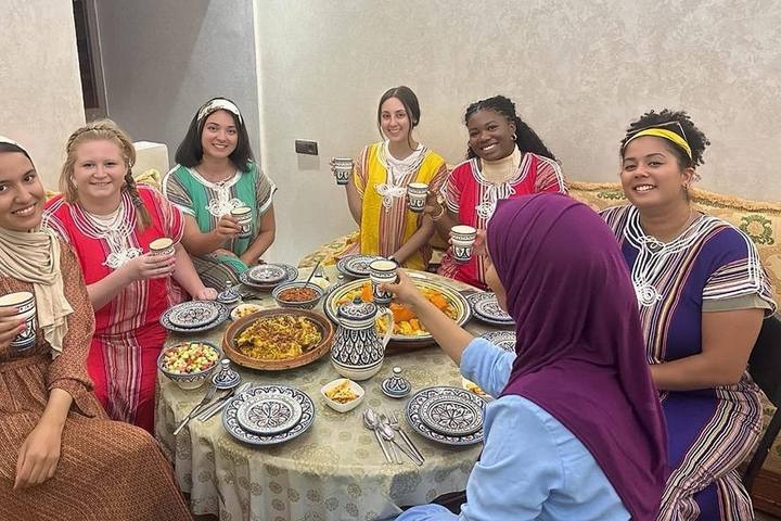 Women guests in caftans around the dinner table