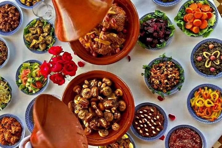 Tagine surrounded by colourful Moroccan salads, seen from above